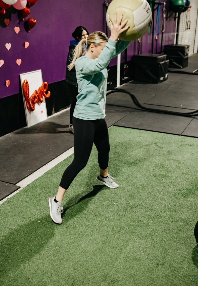 A member throwing a medicine ball during a circuit